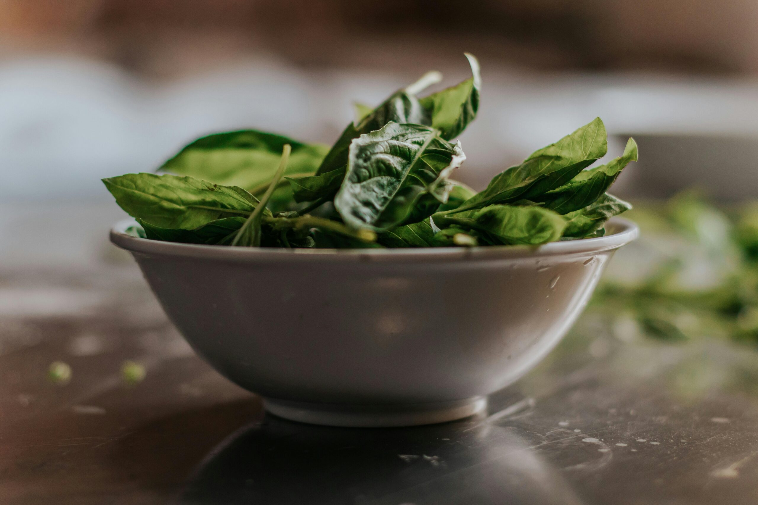 Green Leaves in White Ceramic Bowl